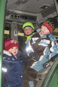 Three mini people in a tractor